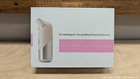 Retail box shows front side of the A1 Intelligent Visual Blackhead Remover with product photo and features.