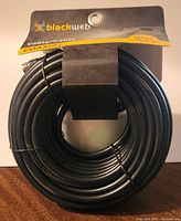 Photo of the coiled Blackweb branded coaxial cable with packaging showing 50ft length and coaxial type.