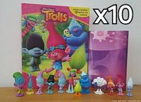 Photo showing one set of DreamWorks Trolls My Busy Books storybook, 12 colorful Trolls figurines, and a playmat with Trolls characters in bright colors