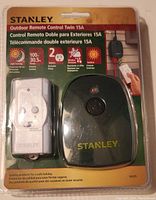 Front packaging showing product and key features such as light sensing, 100W bulb capacity, 2 outlets, weather resistance, and outdoor use.