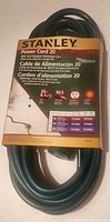 Photo of the Stanley 20 ft outdoor extension power cord in original packaging showing label details including cable gauge 16/3, length 20 ft / 6.1 m, and power ratings.