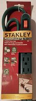 Front view of Stanley PowerMax power strip in packaging showing 6 outlets, on/off switch, brand and cable specifications.
