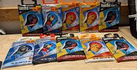 Ten packaged Supersled nylon frameless kites displayed with various themes visible including The Lion King, Spider-Man, and other colorful characters and animals.