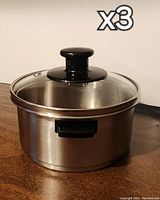 Photo of one stainless steel steamer with glass lid and black handle viewed from the side with x3 overlay indicating a set of three identical steamers.