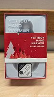 Box of Yetiboy Hand Warmer K-1071 showing front packaging with winter trees and product name.