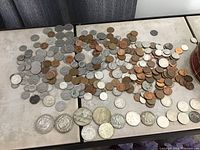 Spread of mixed US coins including silver dollars, half dollars, quarters, dimes, nickels, and pennies