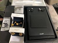 Photo of all four sets of cufflinks displayed together on a flat surface showing different styles and original packaging.