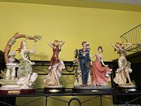 Photo of four Giovanni Art figurines on display shelf showing front view of all figurines