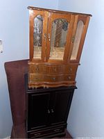Two wood jewelry boxes stacked, showing the size difference and overall appearance with glass doors and wood finish.