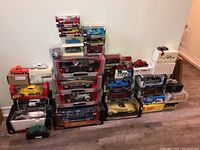 Overall lot, stacked boxes of model cars on floor against wall