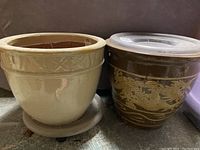 Both planters side by side, showing size, color, and bases with rollers.