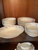 Three stacks of bowls on upper shelf — two sizes of bowls