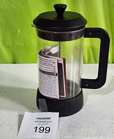Closed GSI Outdoor Java Press with instruction manual visible inside, displaying overall shape and condition
