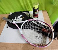 Photo showing Head Liquid Metal Lady Pro II tennis racket, Wilson Staff case, and unopened pack of 3 Penn Championship tennis balls.