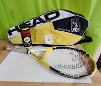 Head Titanium Men ATP Master tennis racket displayed with official Head ATP zippered bag and canister of 3 Penn Championship tennis balls