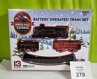 Image of unopened North Pole Express battery operated train set in original box showing locomotive, tender, passenger car, and track pieces