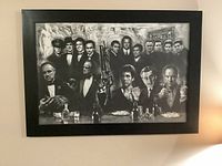Framed black and white photographic print showing iconic mafia gangsters in tuxedos and suits, several holding guns and drinks, vintage style.