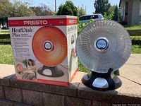 Photo showing the Presto HeatDish Plus heater next to its original box outdoors.