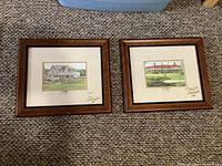 Pair of signed framed golf prints laid on carpet showing both items side by side.