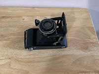 Top side view of the Voigtlander folding camera showing lens and upper body