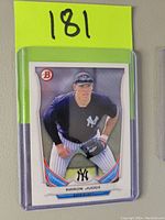 Front image of 2014 Bowman Aaron Judge baseball card showing player in Yankees uniform in ready stance with Bowman logo.