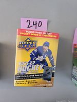Front of 2021-22 Upper Deck hockey card blaster box showing player in blue jersey, brand and series info.