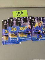 Four unopened UEFA 2024 Euro Soccer trading card packs displayed together, showing front packaging with player image and promotional text.