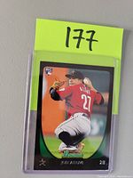 Front side of Jose Altuve Bowman rookie baseball card with player pitching in Astros attire and rookie emblem.