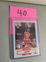 Front view of the 1990 Fleer basketball card showing Michael Jordan dunking in red Chicago Bulls uniform number 23, with Bulls logo and player name and position.