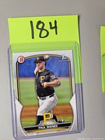Front photo of Bowman Draft Baseball Card featuring Paul Skenes in pitching motion wearing Pittsburgh Pirates black uniform.