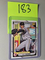 Front of Paul Skenes baseball card in protective sleeve, showing player pitching in Pittsburgh Pirates uniform with Bowman logo.