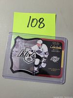 Front side of Wayne Gretzky Team Logos insert hockey card showing player image and logos