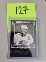 Front of the Upper Deck Portfolio black and white hockey card of Wayne Gretzky in Kings uniform with captain's C.