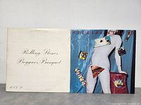 Front covers of the two Rolling Stones albums, Beggars Banquet and Sticky Fingers, shown side by side.