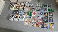Full spread of hundreds of baseball cards in various stacks and singles showing a variety of players and card styles.