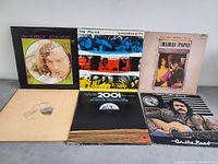 Photo of 6 vinyl LP album covers including Van Morrison, The Police, The Mamas and the Papas and others.