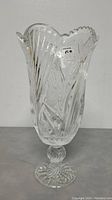 Front angle showing the vase with detailed cut glass patterns and scalloped rim.