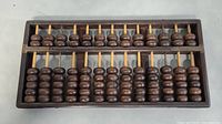 Front view of the vintage wooden abacus showing all 13 rows of wooden beads and the rectangular frame.