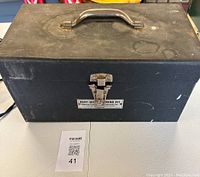 Closed black metal carrying case with handle and latch showing the label Heat Bonding Sealing Kit