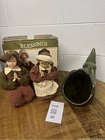 Front view of male and female pilgrim figurines with the green cornucopia and original box behind