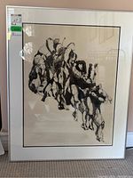 Full view of the framed artist proof print showing abstract humanoid forms in black ink on white background.