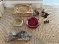 Overview photo showing all 8 items including stone and glass ashtrays plus decorative mineral pieces on carpeted floor.