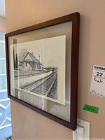View of the framed print hanging on a wall, showing the full artwork with a clear wooden frame measuring approximately 17x21 inches.