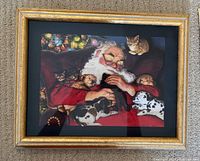 Framed 3D art print featuring Santa Claus sleeping with cats and a Dalmatian dog on his lap, presented in a gold-tone frame with black matte
