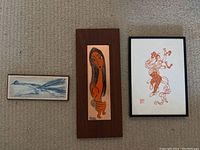 Overall view of the three wall decor pieces shown together, different sizes and styles.