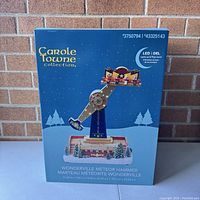 Front view of the Carole Towne Wonderville Meteor Ride new in box with blue winter-themed packaging.