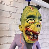 Close-up of Frankenstein monster's face showing detailed paint and facial scars