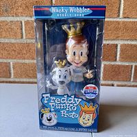 Front view of the Freddy Funko with Proto bobble head in original packaging showing character and logos.