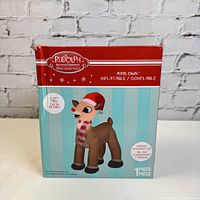 Box front showing Rudolph the Red Nose Reindeer inflatable product image and branding including specifications like 3.5 feet tall, energy efficient LED nose light, airblown inflatable.