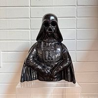 Front view of the black glossy ceramic Darth Vader lamp with detailed sculpting